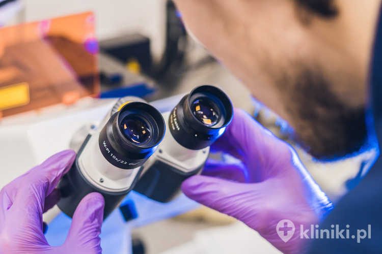 Naukowiec pracuje nad konfokalnym mikroskopem skaningowym w laboratorium do badania próbek biologicznych
