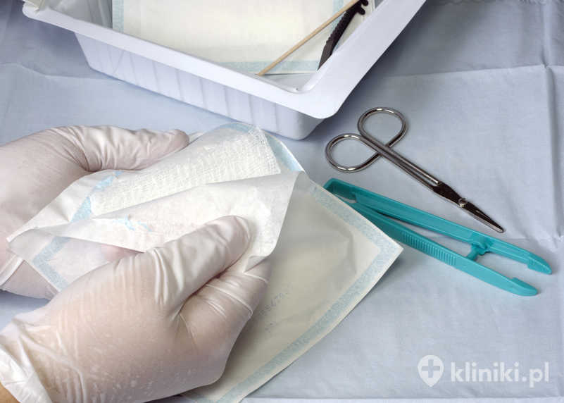 Pielęgniarka przygotowuje do użycia materiały z opatrunku na ranę Pielęgniarka przygotowuje do użycia materiały z opatrunku na ranę